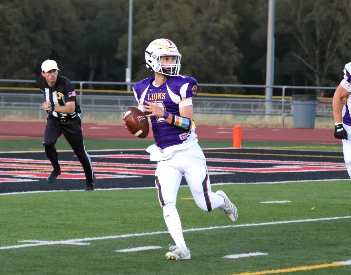 Football official following a quarterback during a play